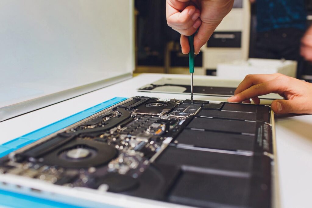 Engineer repairs laptop pc computer motherboard installs equipment cpu 152904 52548